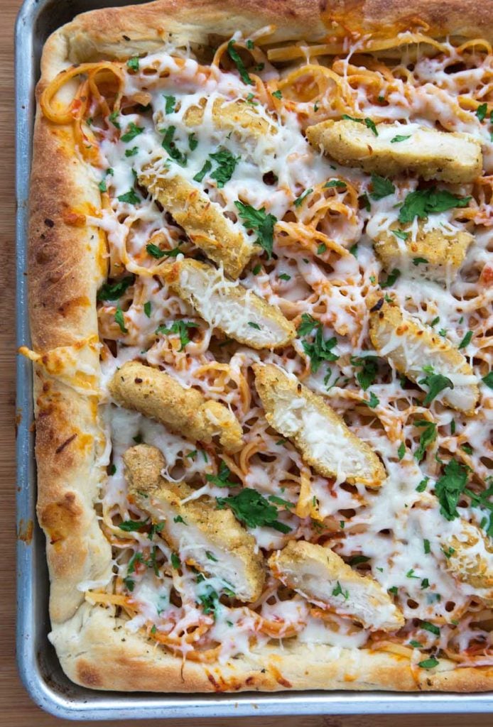 overhead shot of chicken parm pizza baked in a sheet pan