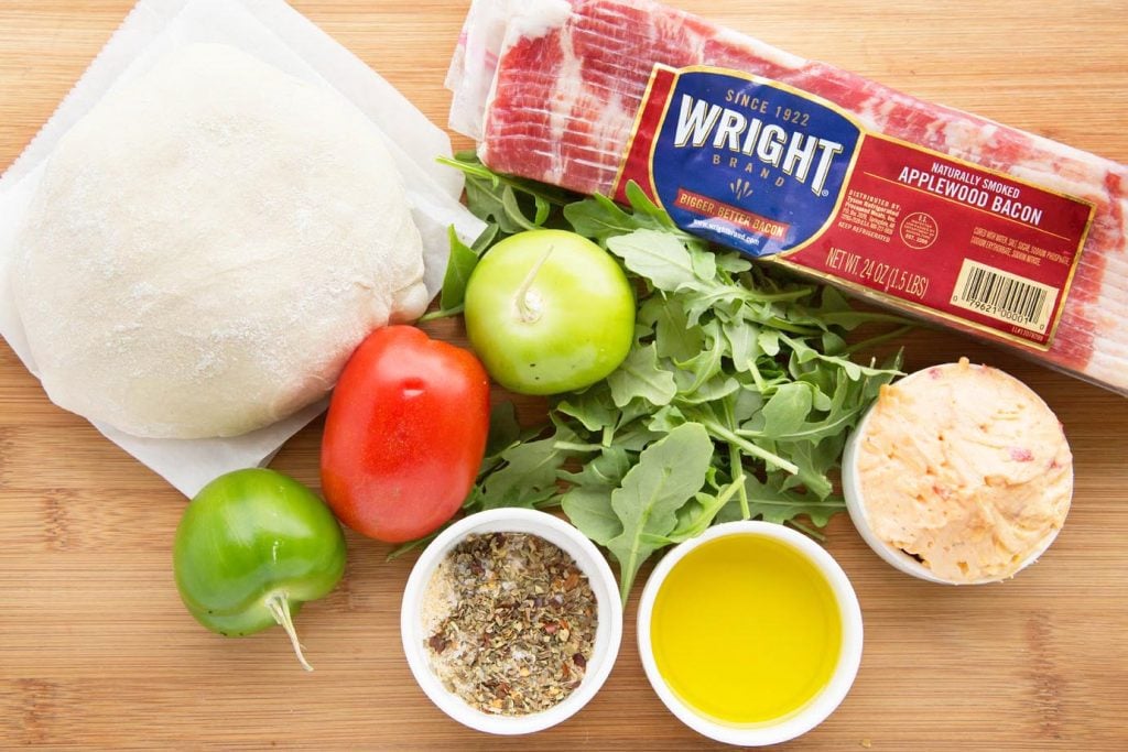ingredients to make southern style pizza on a cutting board