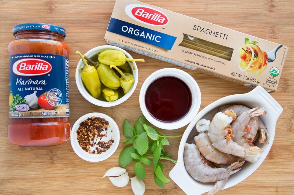 overhead view of ingredients to make shrimp fra diavolo on a wooden cutting board