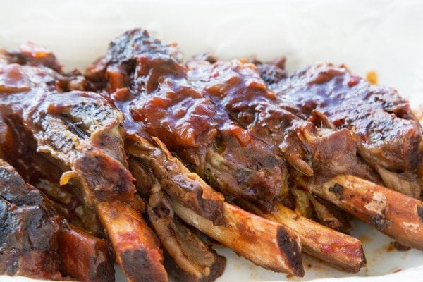 side view of slow cooker beef ribs on a white plate