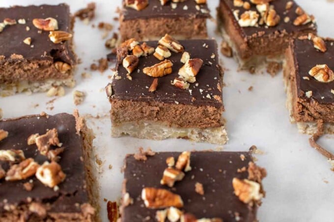 cut chocolate cheesecake bars on a white surface