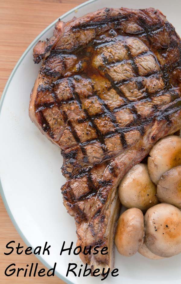 grilled ribeye with crosshatch grill marks on a plate with baby potatoes