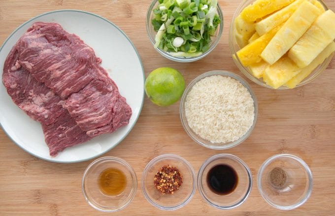 Ingredients to make Big Island Steak Bowl in glass bowls and plates