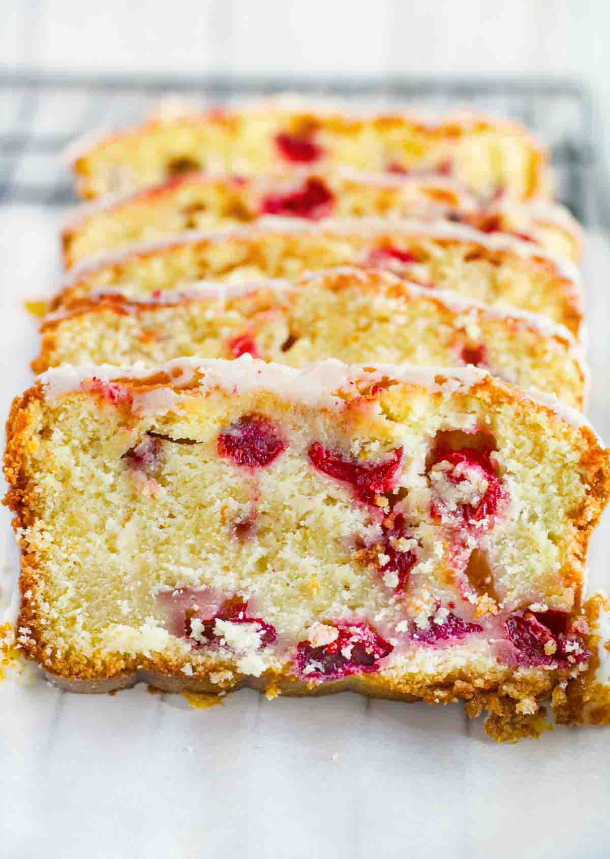 slices of cranberry orange bread on a white deli paper.