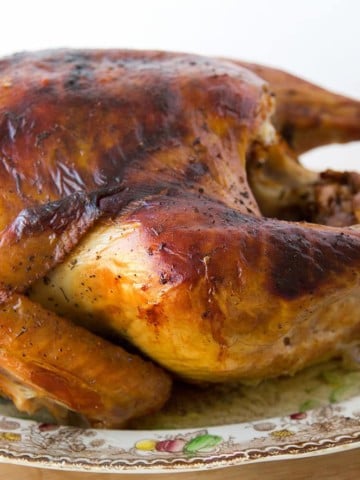 side view of a dry brine roasted turkey on a Thanksgiving platter