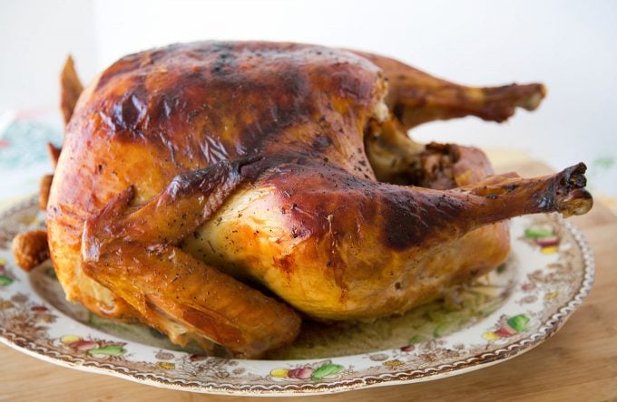 side view of a dry brine roasted turkey on a Thanksgiving platter