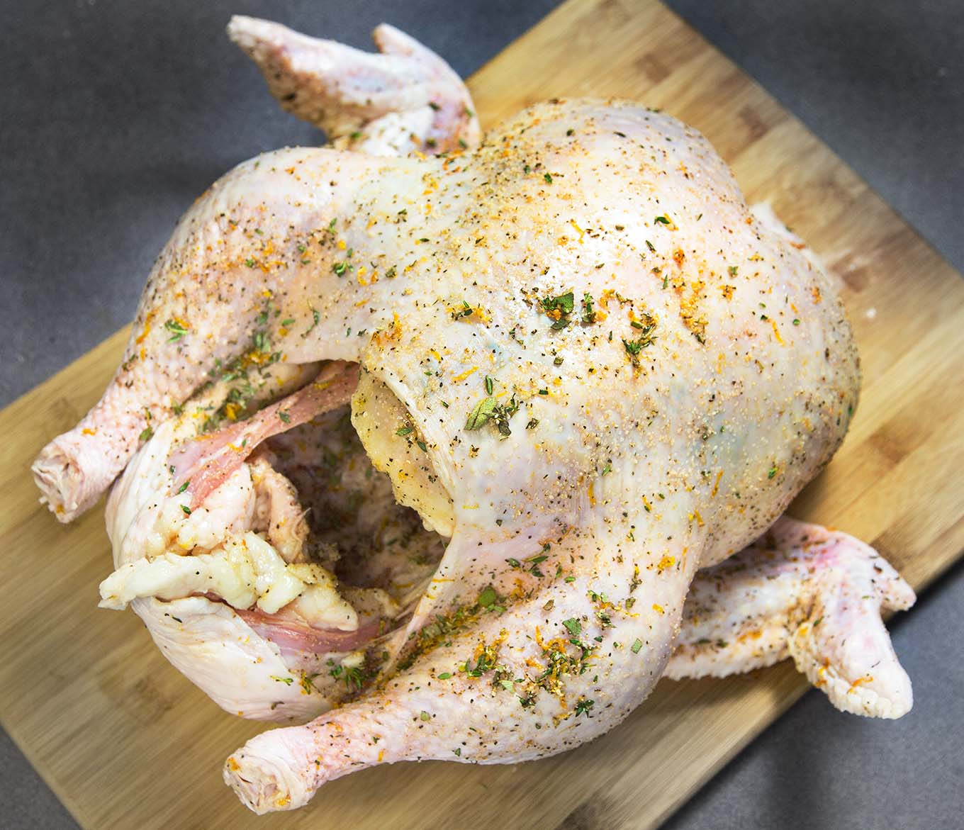 raw turkey on a cutting board seasoned with dry brine