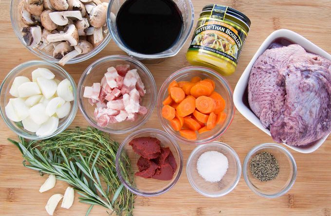 ingredients to make Coq au Vin on a wooden cutting board