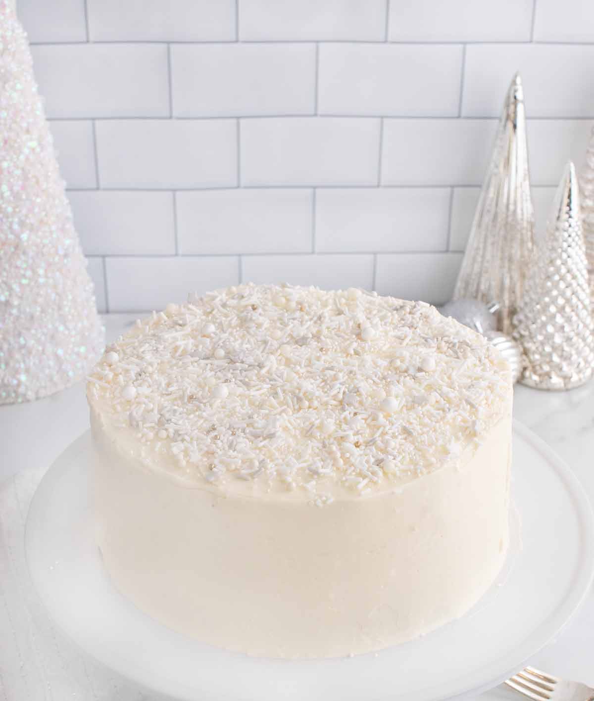 whole winter wonderland white cake on a white platter