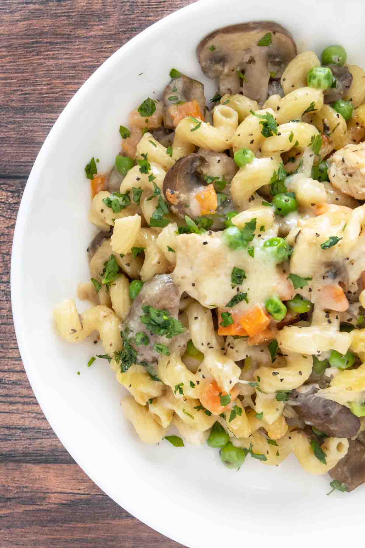 Chicken and mushroom pasta bake in a white bowl