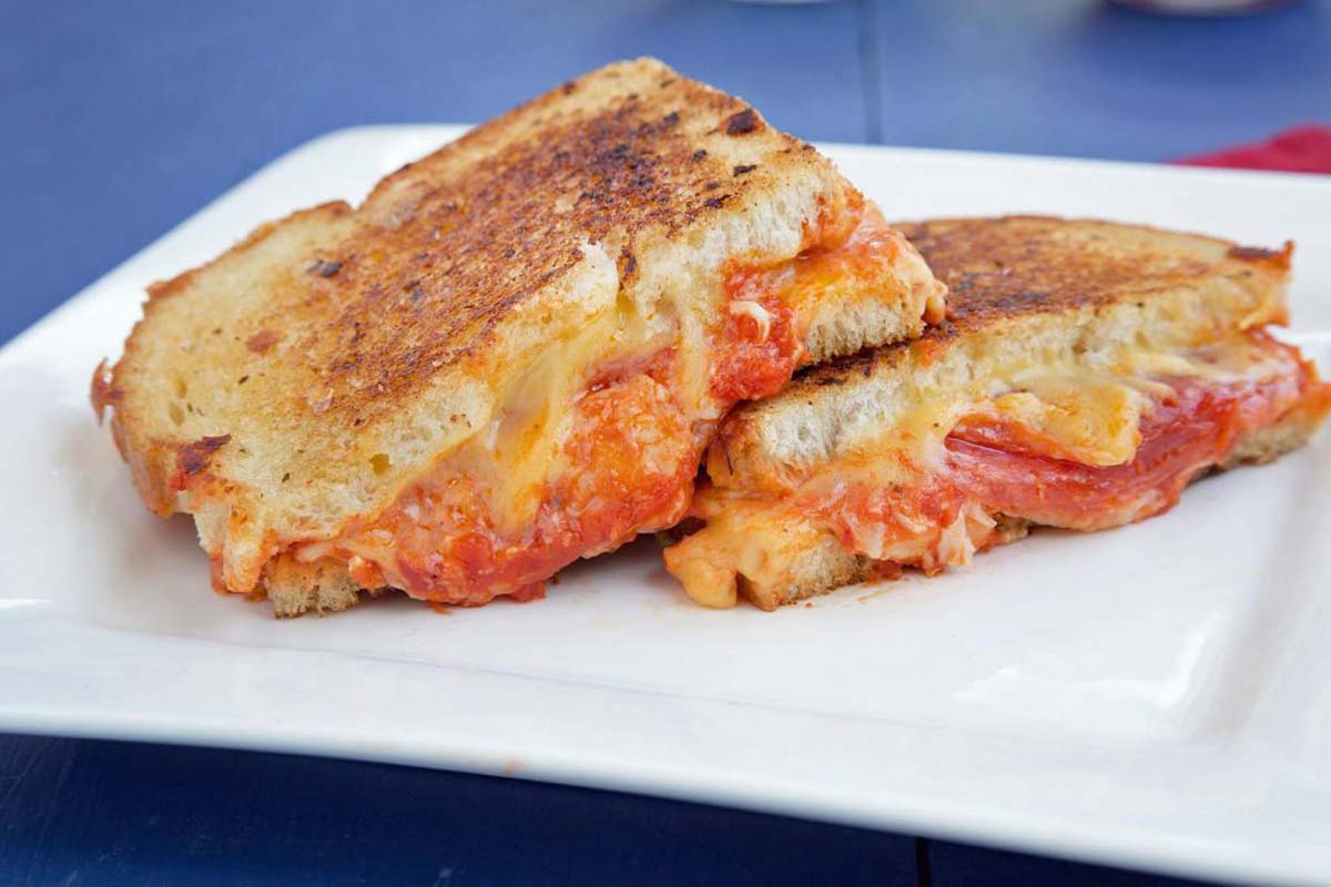 Pepperoni Pizza grilled cheese sandwiches on a white plate