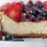 slice of cheesecake on a plate with berries