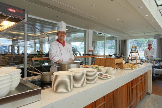 chef serving the buffet line at the Aquavit Terrace on a Viking River Cruise