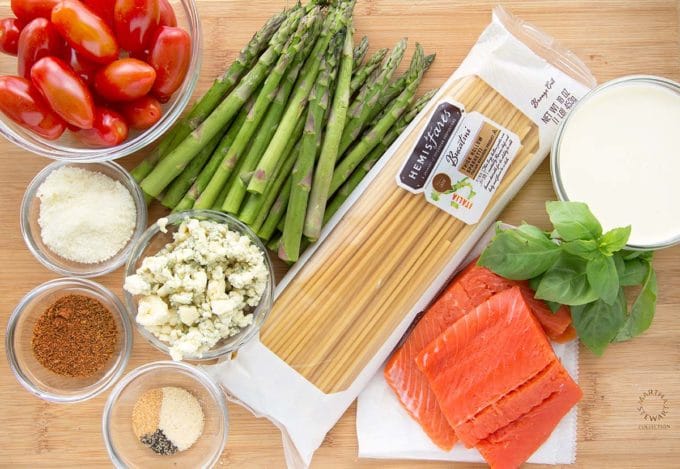 overhead view of ingredients to make bucatini with blackened salmon, apsaragus and tomatoes