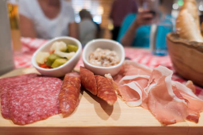 assortement of meats and accompaniments on a cutting board