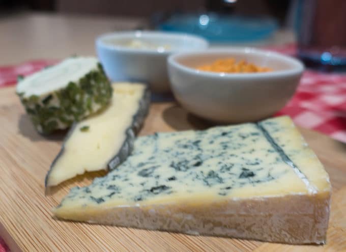 selection of cheese and toppings on a cutting board