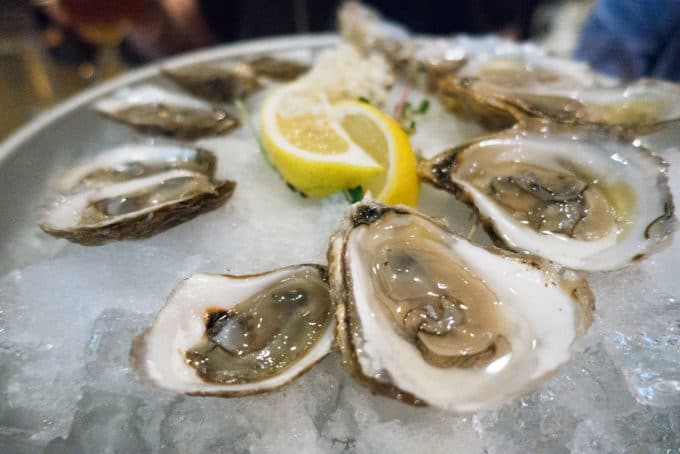 oysters on ice with lemons 