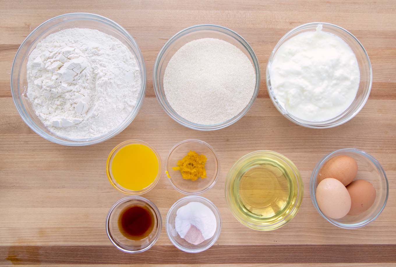 ingredients to make a yogurt cake in glass bowl