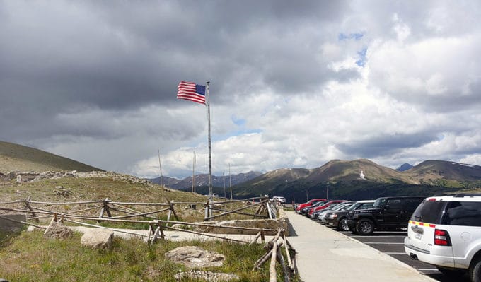 American Flag waving at the top of the mountain in Rocky Mountain National Park