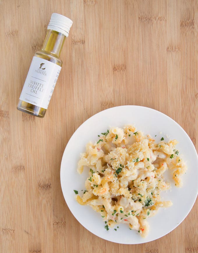 white truffle oil with a plate of mac and cheese on a cutting board