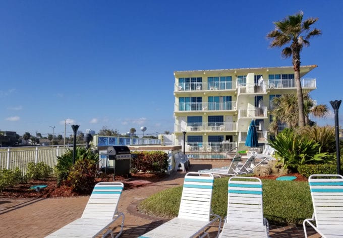 Sea Shells Resort Beach Club , view of hotel and pool with beach chairs in the foreground