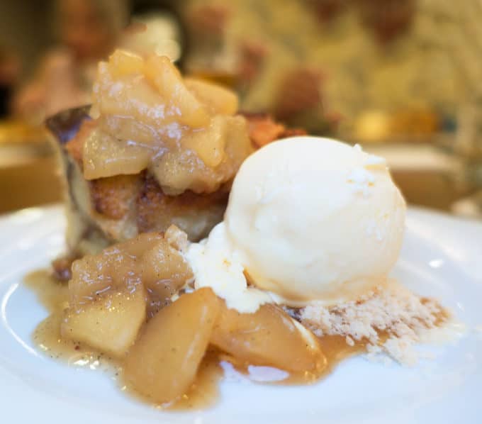 apple bread pudding with cooked sliced apples and vanilla ice cream 