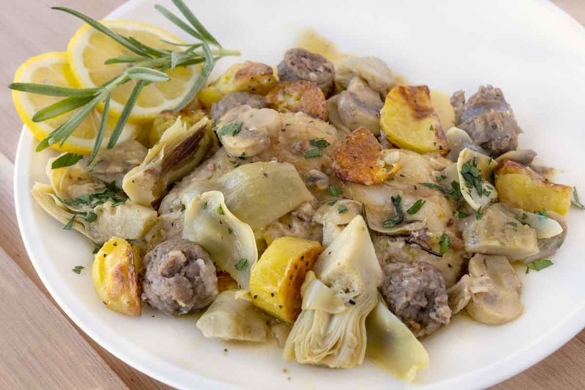 close up of chicken scarpariello on a white plate