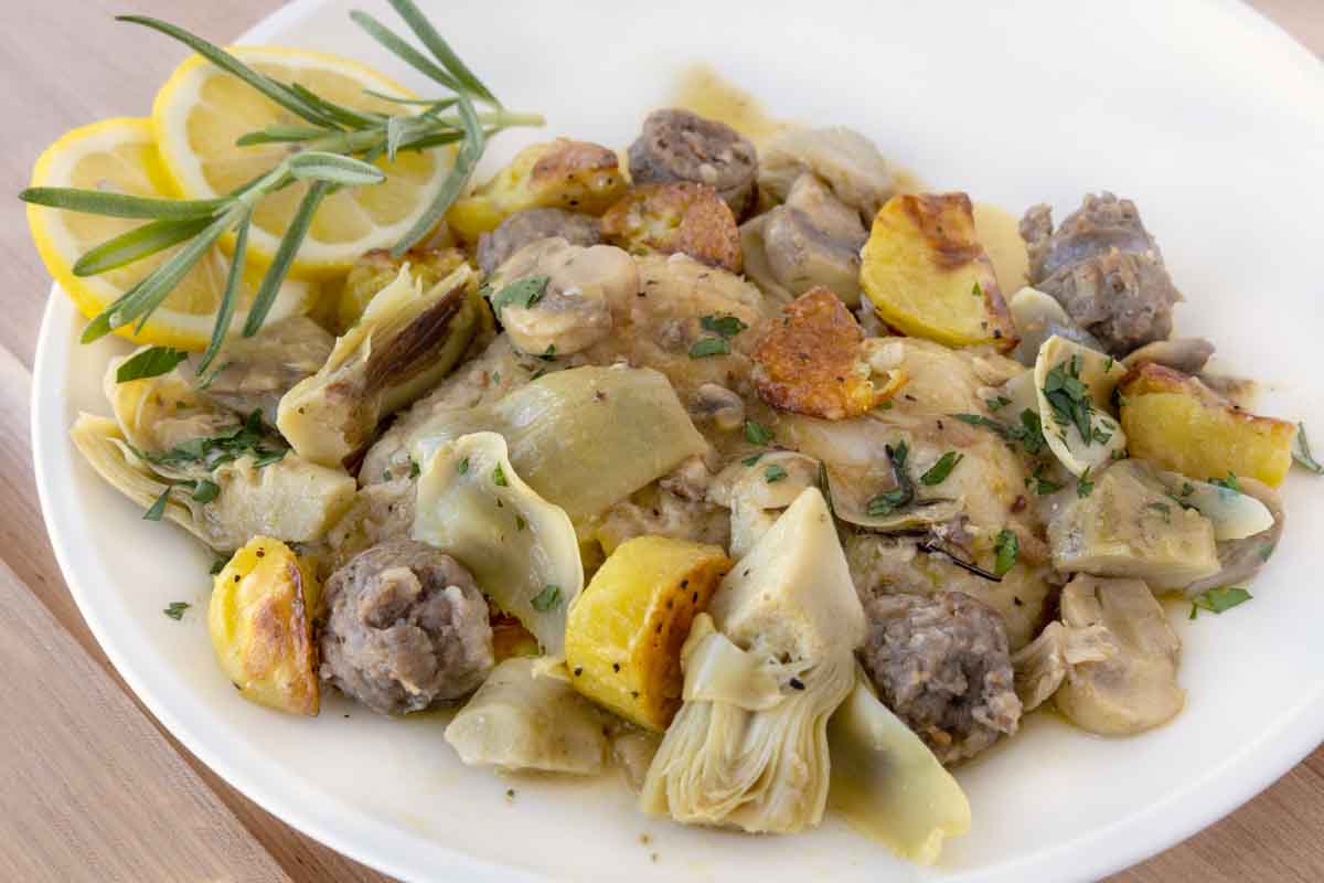 close up of  chicken scarpariello on a white plate