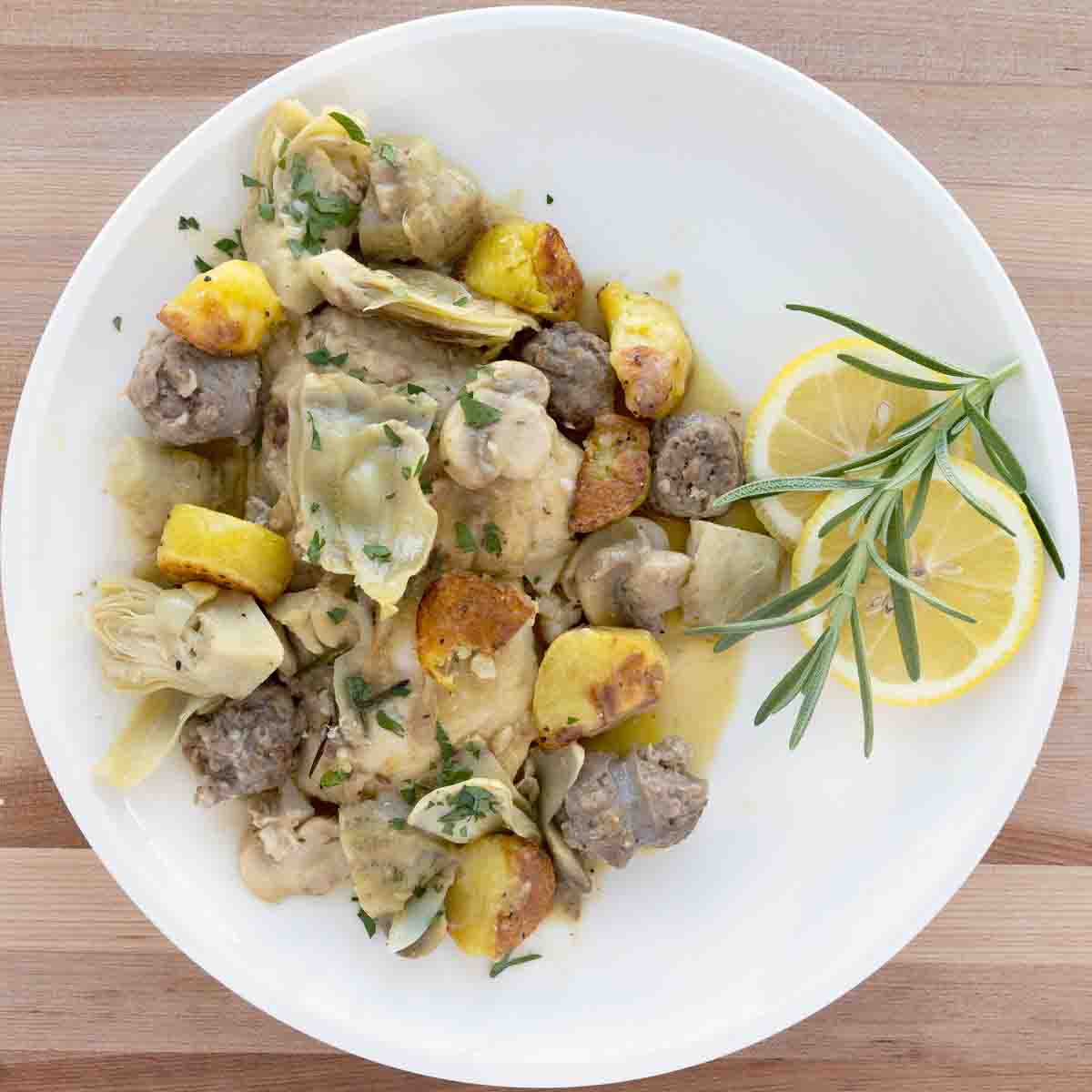 overhead view of chicken scarpariello on a white plate