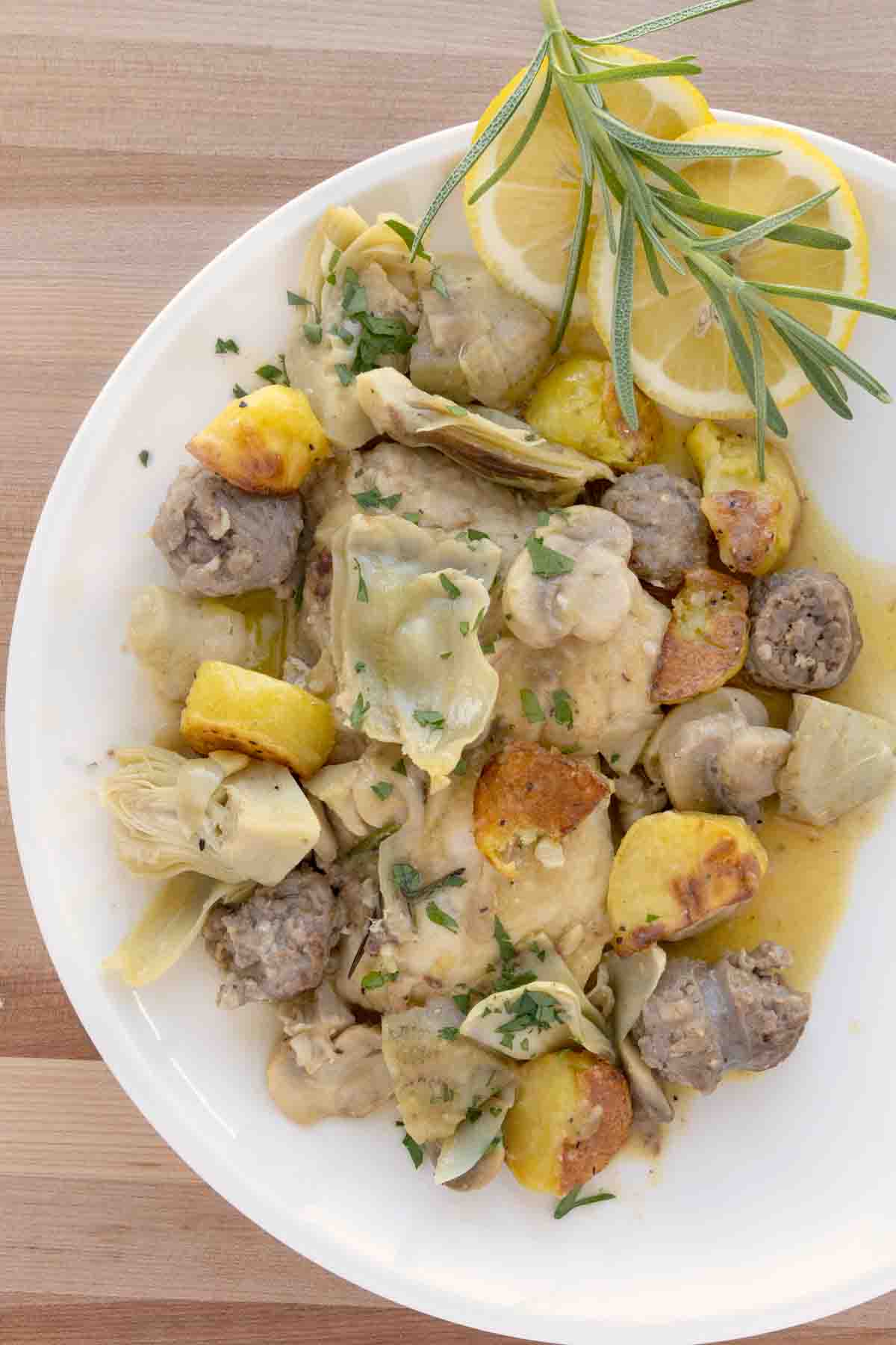 overhead view of chicken scarpariello on a white plate