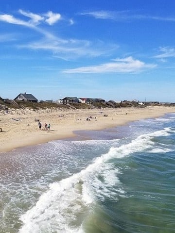 view of the beach and ocean with a blue sky in the Outer Banks of North Carolina