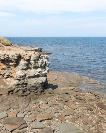 Cliffs in Caraquet, New Brunswick overlooking the St. Lawerence Bay and a slate covered shoreline