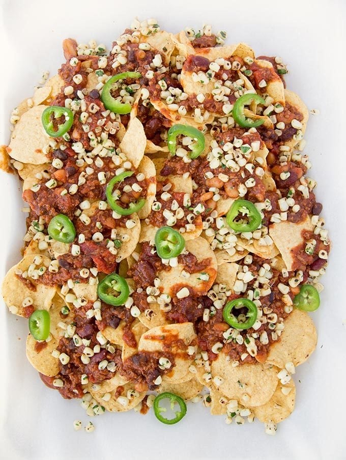 corn chips topped with chili and beans, roasted yellow corn kernels, and sliced jalapeños 