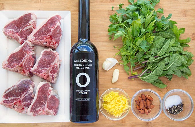 mise en place for marinated grilled lamb chops sitting on a cutting board