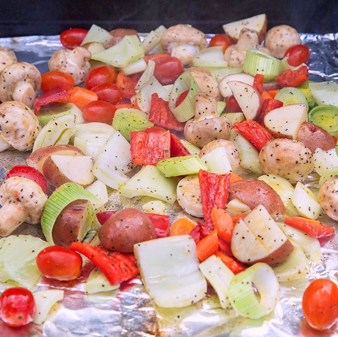 cut vegetables on aluminum foil on the grill