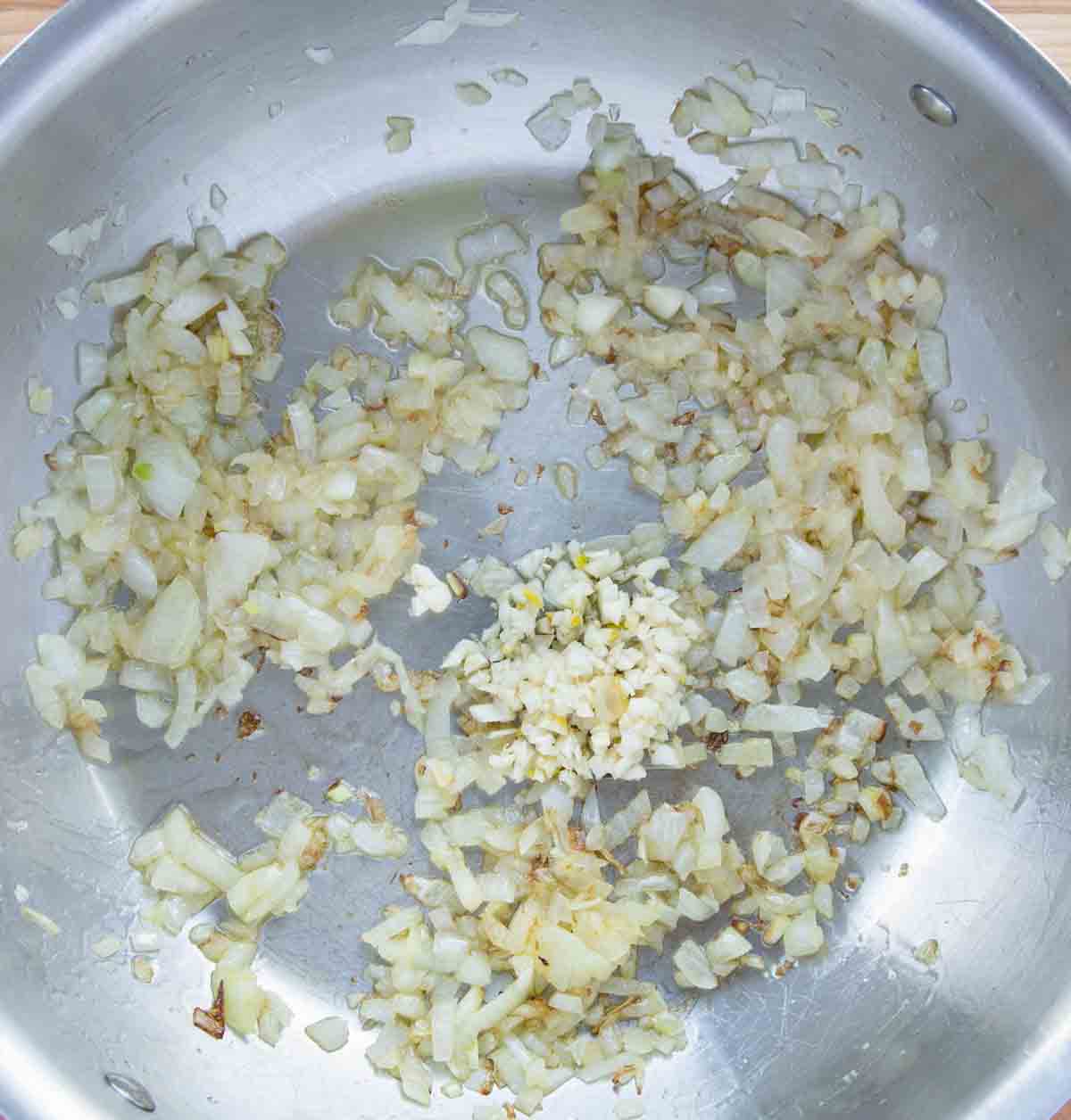 garlic added to pot with sauteed onions 