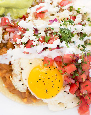 Huevos Rancheros with a sunny side up fried egg sitting on a white plate