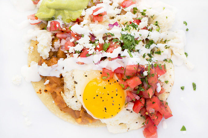 Huevos Rancheros with a sunny side up fried egg sitting on a white plate
