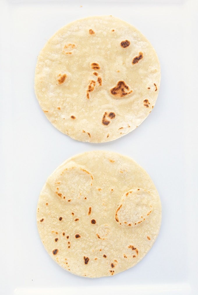 grilled tortillas on a white platter.