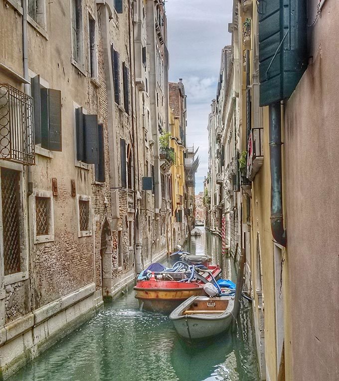 canals of venice with boats in the water