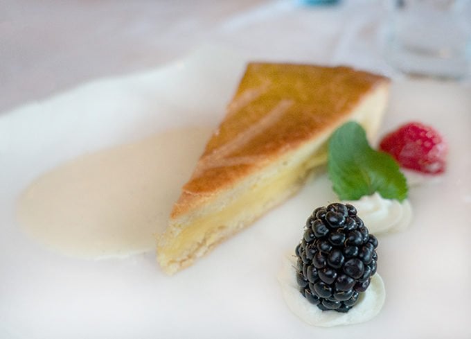 slice of a Basque Cake on a white plate with berries