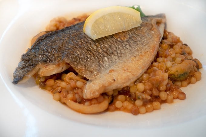 seared dorado with skin on served on a bed of fregola 