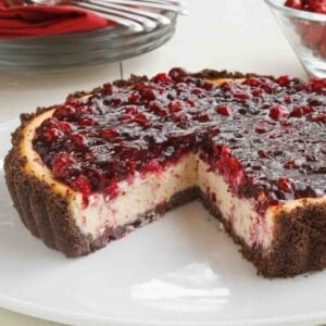 amethyst cheesecake with slice cut out on a white platter