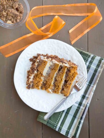 pumpkin crunch cake slice on a white platter with a fork
