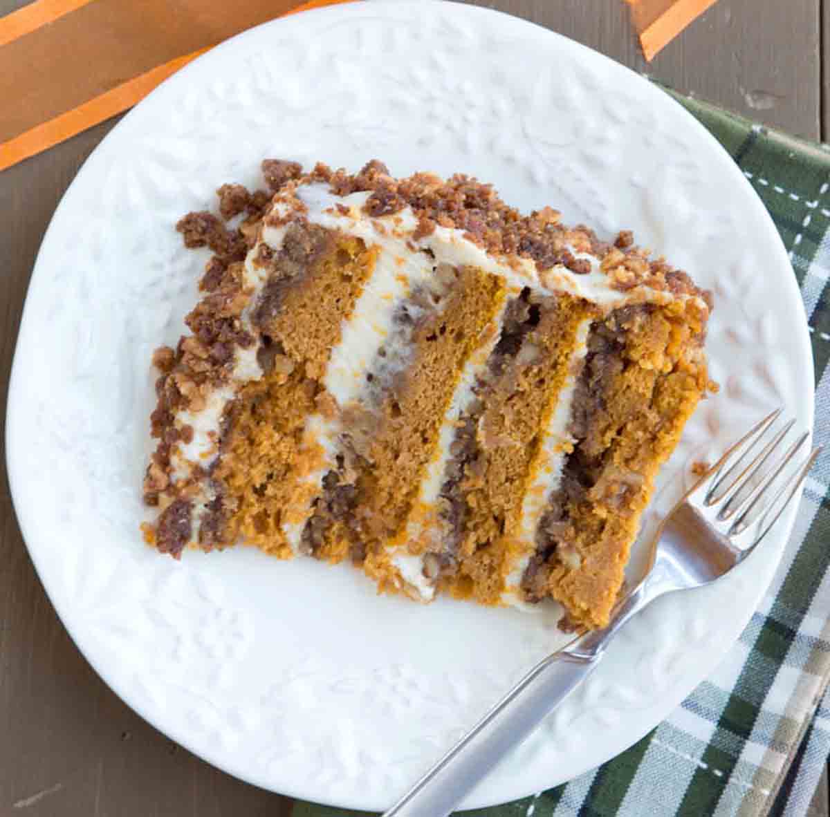slice of pumpkin crunch cake on a white platter with a fork