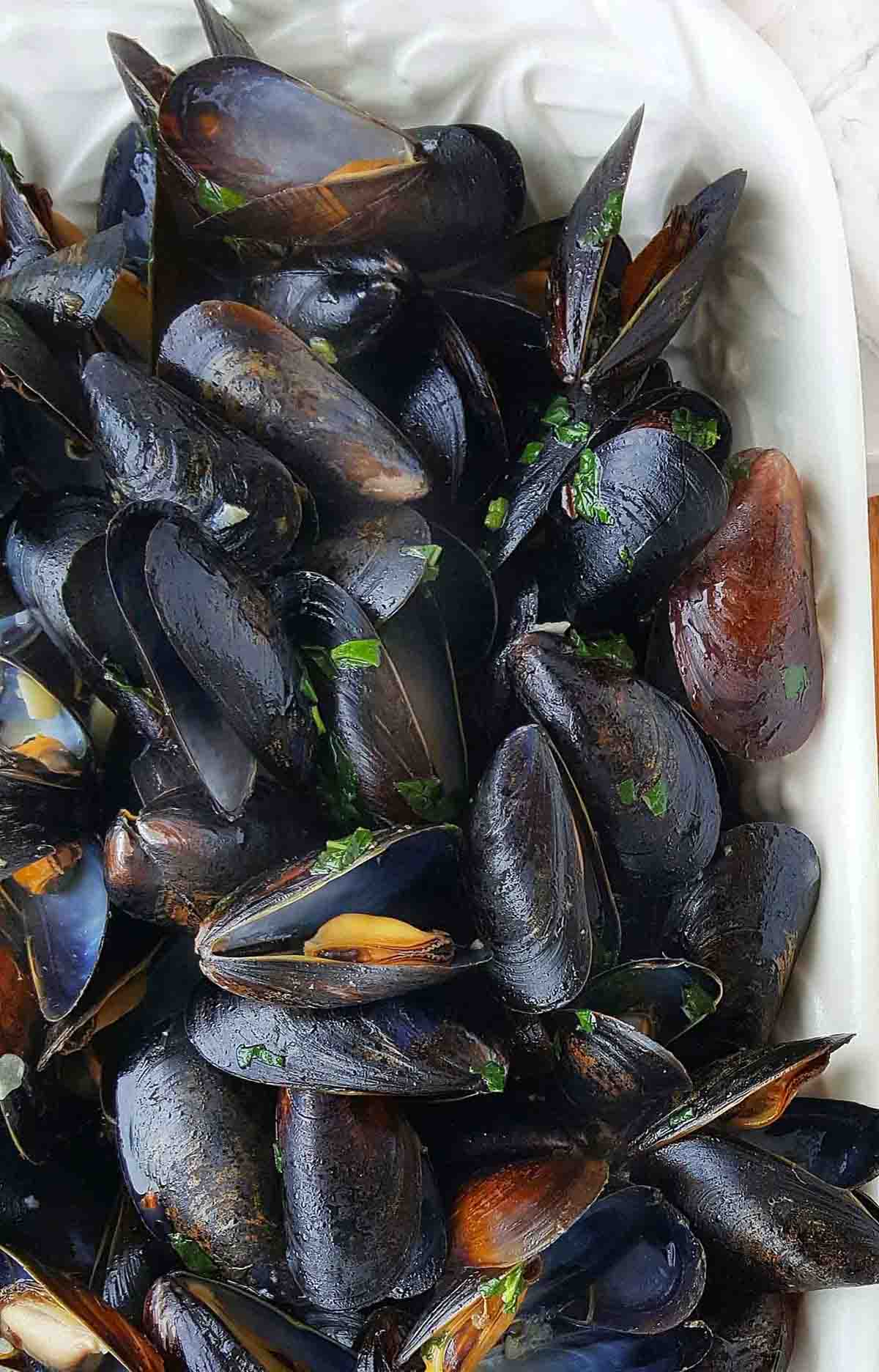 steamed mussels in a white platter