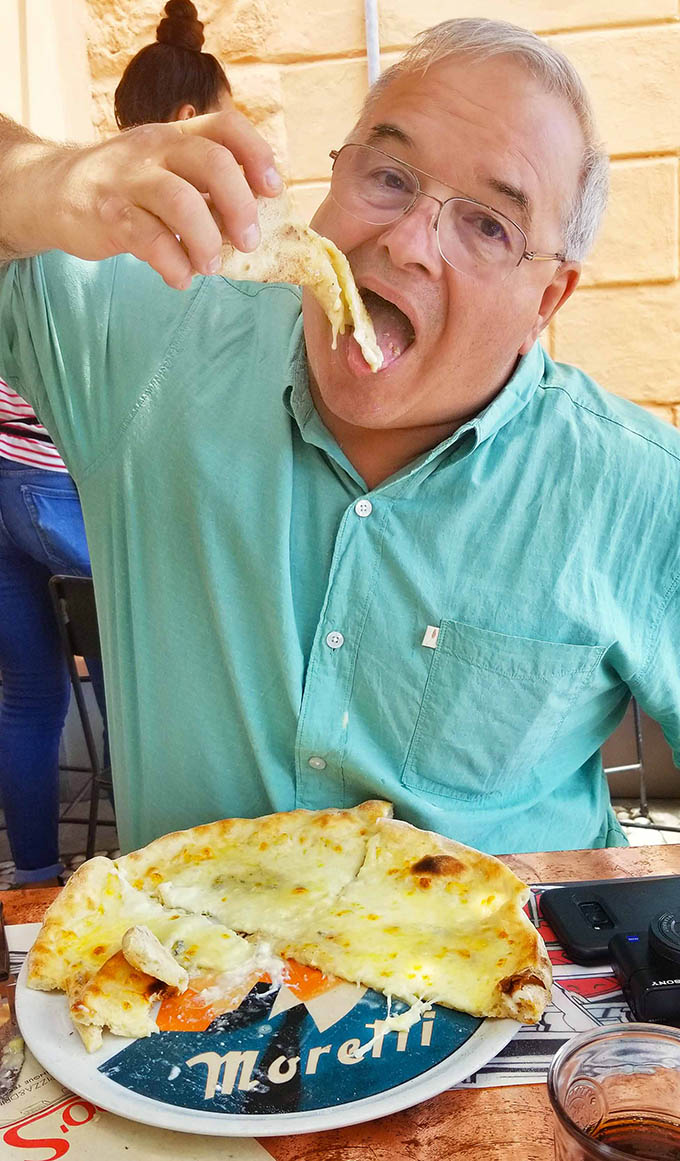 Chef Dennis eating a four cheese pizza in the Cinque Terre
