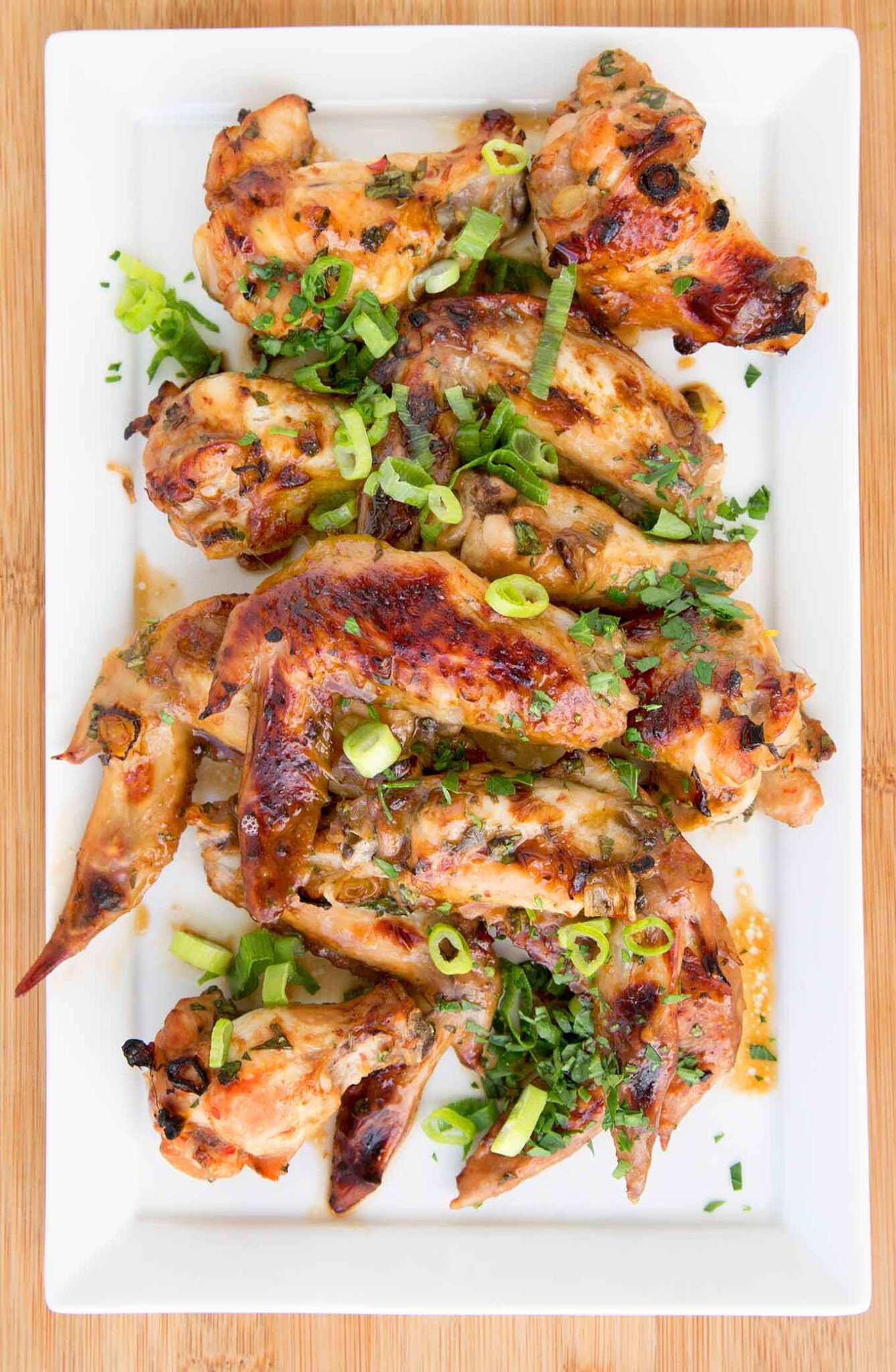 garlic ginger wings on white platter