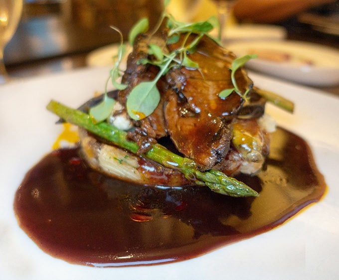 braised short ribs with a red wine demi glace on a white plate