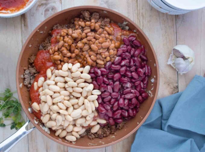 spaghetti sauce and beans added to the pan with ground beef